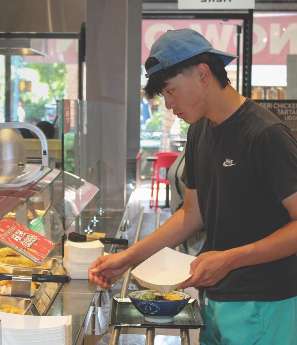 Senior Gus Soedarmono selects food at a the "Tempura Bar" at Marugame Udon
