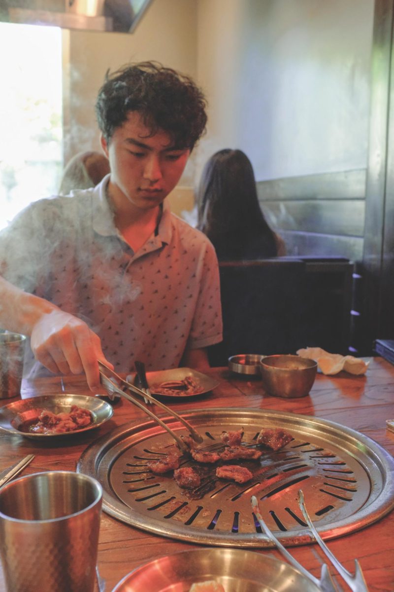 Senior Marcus Ling dives into cooking his barbeque meal