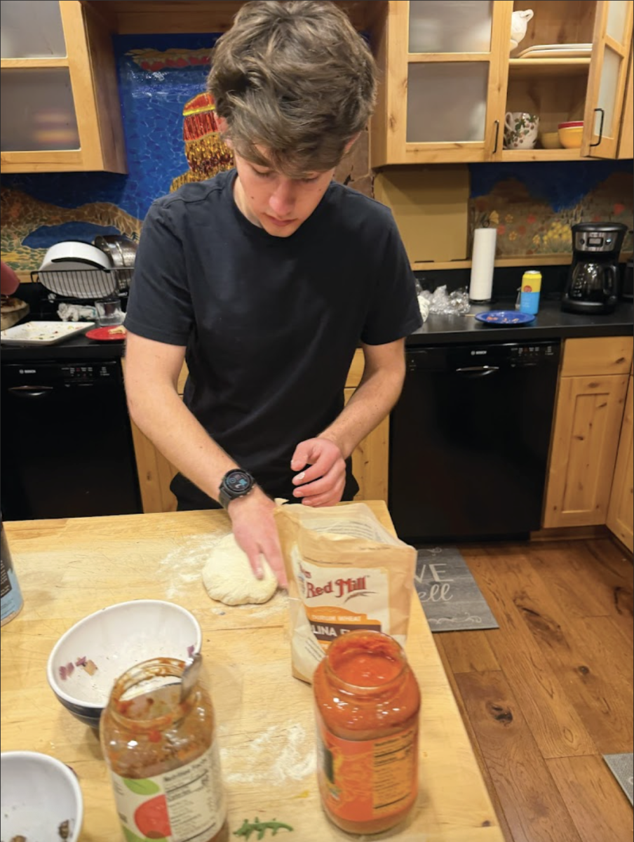 KNEADING Vostrejs skillfully spreading and rolling out the pizza dough to achive the perfect plumped crust and bite.